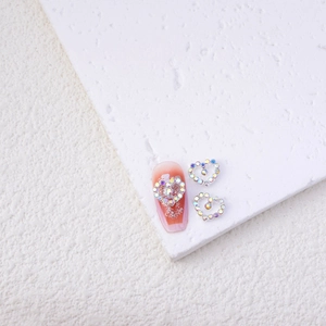 Macro shot of silver alloy hollow heart nail charms with sparkling colorful rhinestones