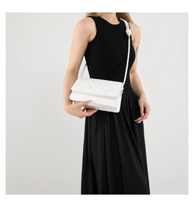 White quilted crossbody bag for women featuring a unique knot detail on the shoulder strap