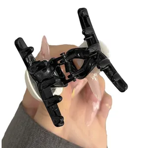 Black plastic panda hair claw clip with multi-tooth design and glossy finish
