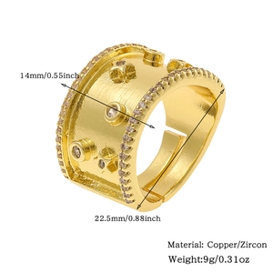 Detail shot of 14mm wide gold plated open ring with star relief and zircon stones