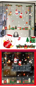 Detail of Christmas window clings featuring Santa, reindeer, and snowflakes on glass