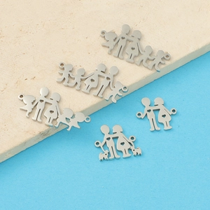 Flat lay of stainless steel family silhouette pendants with children and pets on stone