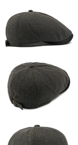 Detail of herringbone wool newsboy cap showing grey texture and metal adjustable buckle