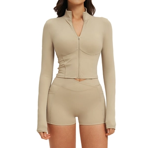 Women's beige athletic set with long sleeve zip-up top and high-waist V-cross shorts
