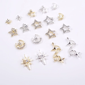 Macro shot of 3D alloy stars and moon nail charms with inlaid rhinestones and pearls