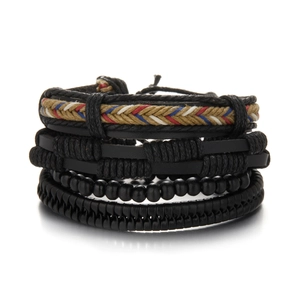 Close-up of four stacked men's bracelets featuring braided leather and tricolor details