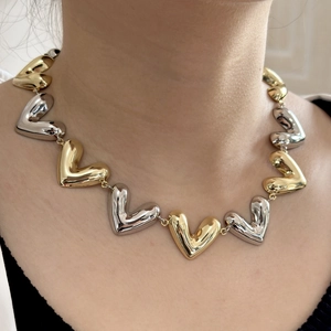 Elegant gold and silver heart link necklace displayed on a model for daily wear