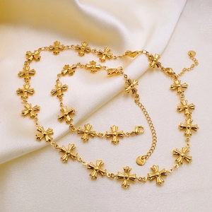 Byzantine style stainless steel cross necklace with gold finish on white silk background