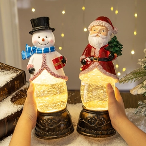 Christmas lanterns with Santa and snowman figurines and warm LED glitter lights