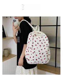Corduroy backpack for women featuring red strawberry prints and large front pocket