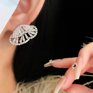 Silver hollow butterfly earrings with sparkling cubic zirconia on a female model closeup