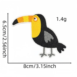 Detailed embroidery of a tropical toucan patch with 8x6.5cm size dimensions shown