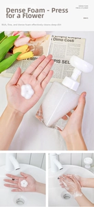 Detailed view of the flower-shaped foam dispenser pump with dense floral foam in hand