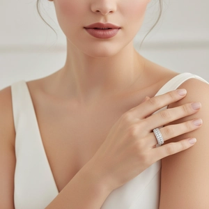 S925 sterling silver moissanite wide band engagement ring worn by a female model