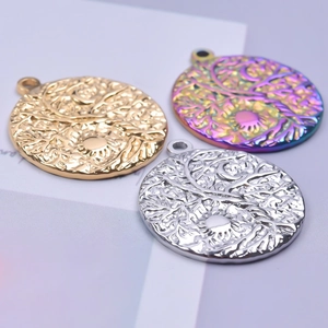 Macro shot of 18K gold and silver Tree of Life pendants with sun and moon motifs