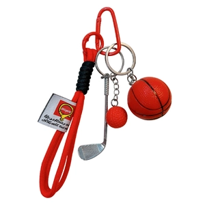 Sports-themed keychain featuring a basketball and golf club charms on a red woven cord