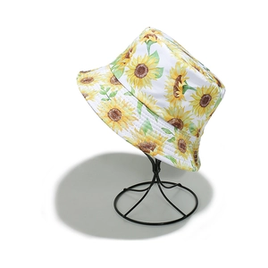 White bucket hat with sunflower print for summer sun protection on white background