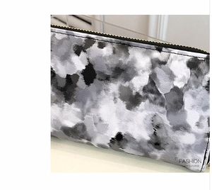 Close-up of long marble pattern wallet with high-quality gold metal zipper for women