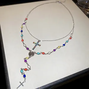 Silver multi-layer Y-necklace with colorful rhinestones, cross pendant, and relief medal
