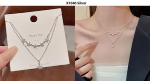 Close-up of double-layer silver star necklace with zircons on model and card