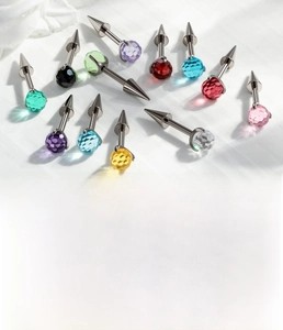 Detailed view of titanium cartilage piercings with multi-faceted colorful crystal balls