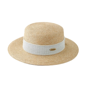 Handcrafted flat top straw sun hat with decorative grey band and gold oval emblem