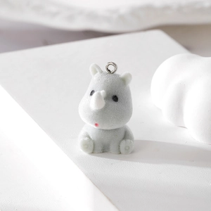 Close-up of grey flocked rhinoceros pendant with silver metal ring for DIY jewelry