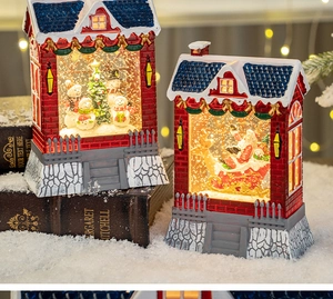 Detail of Christmas water lantern with snowman and Santa scenes in red brick housing