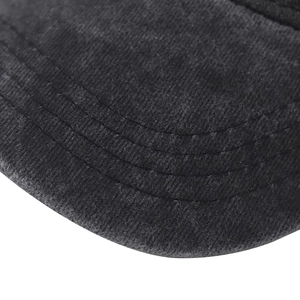 Detail of grey corduroy baseball cap visor showing triple-row reinforcement stitching