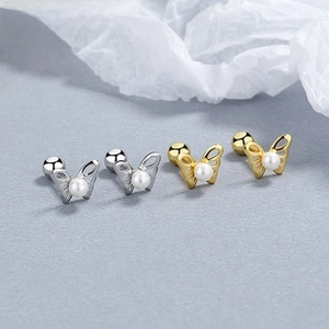 Detailed macro view of 925 silver butterfly pearl earrings with screw back ball closure