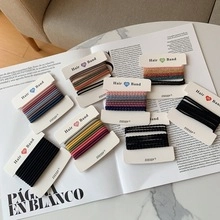 Multi-colored high-elasticity hair bands set displayed neatly on a magazine page