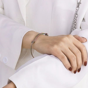 Minimalist rainbow adjustable stainless steel coil bracelet for women on a model