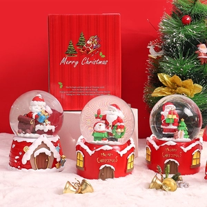 Close-up of Christmas crystal balls with Santa and Snowman figures on red bases