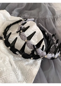 Detailed view of ballet-style spiked headbands with crystal bows and soft fabric wrapping