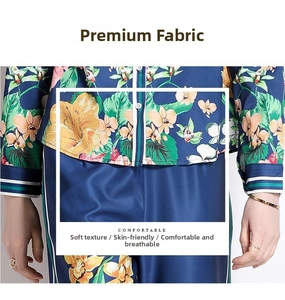 Close-up of floral satin pajama set with green stripe piping and white buttons