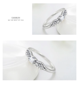 Detailed macro view of S925 silver angel wing ring with sparkling zircon center stone