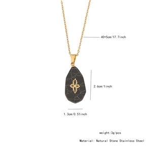 Detailed view of irregular black stone pendant with golden cross and chain dimensions