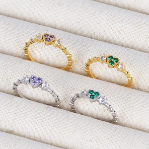 Sparkling heart-shaped 18K gold and silver rings with purple and green zircon stones