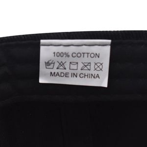 Detailed macro view of 100% cotton baseball cap inner lining and care label