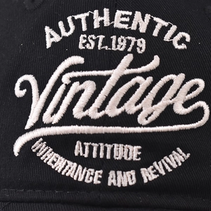 Black cotton baseball cap featuring vintage white embroidery and detailed stitching