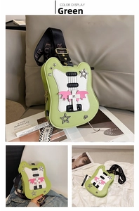Detail of green guitar-shaped crossbody bag with rock star wing and star rhinestones