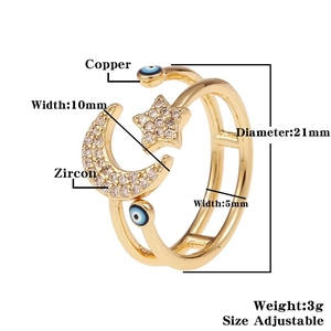 Detailed view of adjustable copper ring with zircon moon, stars and blue evil eye charms