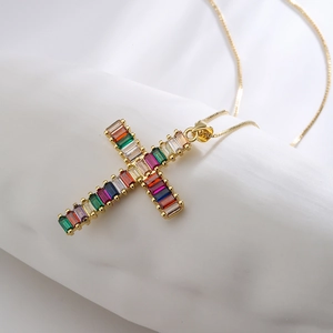 Golden necklace with a geometric cross pendant featuring colorful rectangular zircon stones