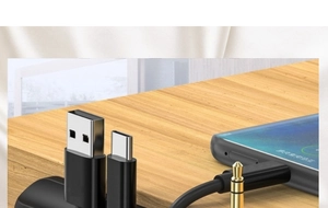 Close-up of a multifunctional USB-C to 3.5mm audio adapter connected to a smartphone