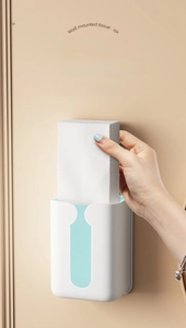 Detail showing the T-shaped large opening of the wall-mounted tissue box for easy access