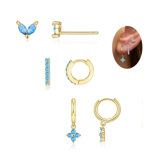 Gold birthstone earring set featuring blue crystals and clover charms for women