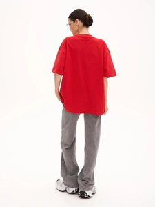 Rear view of oversized red 100% cotton T-shirt showcasing its relaxed fit and drape