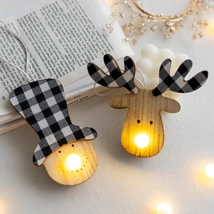 Lighted wooden Christmas ornaments with snowman and deer designs and warm LED lights