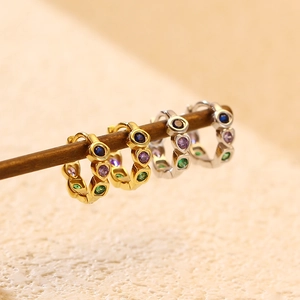 Macro shot of S925 silver heart and round hoop earrings with colorful zircon stones