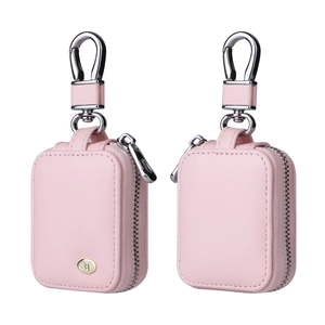 Detail view of pink leather protective case for AirPods with gold musical note emblem